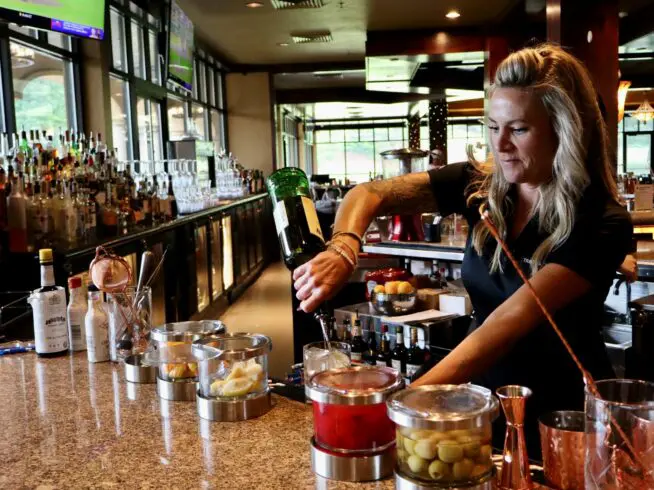 Mandy Brice makes a drink at Trappers Run Golf Club in Wisconsin Dells on Wednesday, June 19. Brice, a first grade teacher, bartends on the side to help pay the bills.