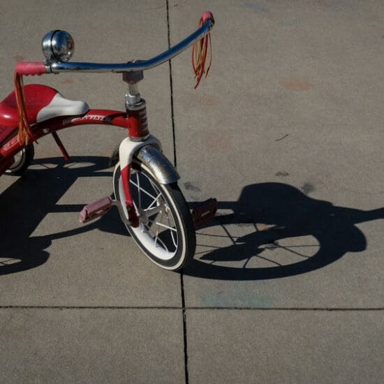 A tricycle on concrete pavement.