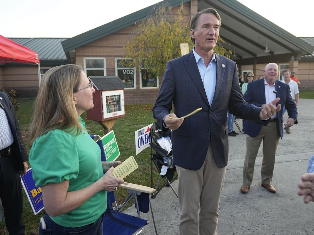 Virginia Gov. Glenn Youngkin, right, hands out sample ballots along with Virginia State Sen. Siobhan Dunnavant R-Henrico, as they greet voters at a polling station Tuesday Nov. 7, 2023, in Glenn Allen, Va. (AP Photo/Steve Helber)