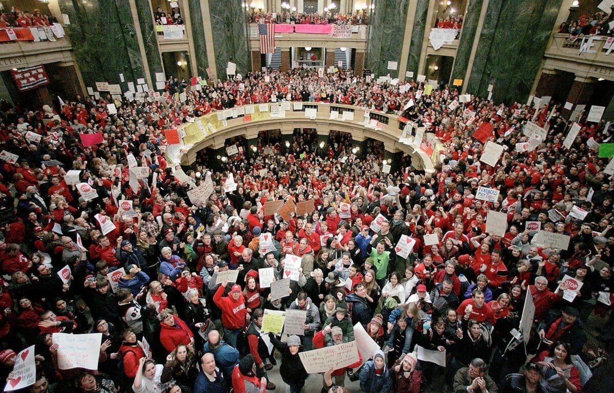 A crowd fills the Wisconsin Capitol rotunda on the fifth day of labor demonstrations, Feb. 16, 2011, in Madison, Wis. Thousands came to protest the governor's proposal to eliminate collective bargaining for most public workers. Seven unions representing teachers and other public workers in Wisconsin filed a lawsuit Thursday, Nov. 30, 2023, attempting to end the state's near-total ban on collective bargaining for most public employees.