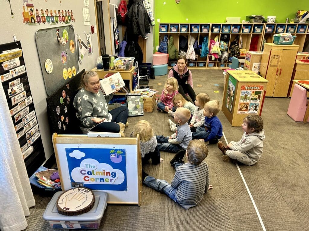 Teacher Paula McGeary reads to her class of 2 and 3 year-olds at Future All Star's Academy in Juneau, WI, on Jan. 16. The child care center has experienced staffing shortages, like many others around the state.