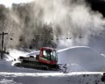 Snow billows from a snowmaker, Tuesday, Nov. 12, 2019, creating piles as Tom Roesler, mountain manager at Mount La Crosse in La Crosse, WI, spreads it out.